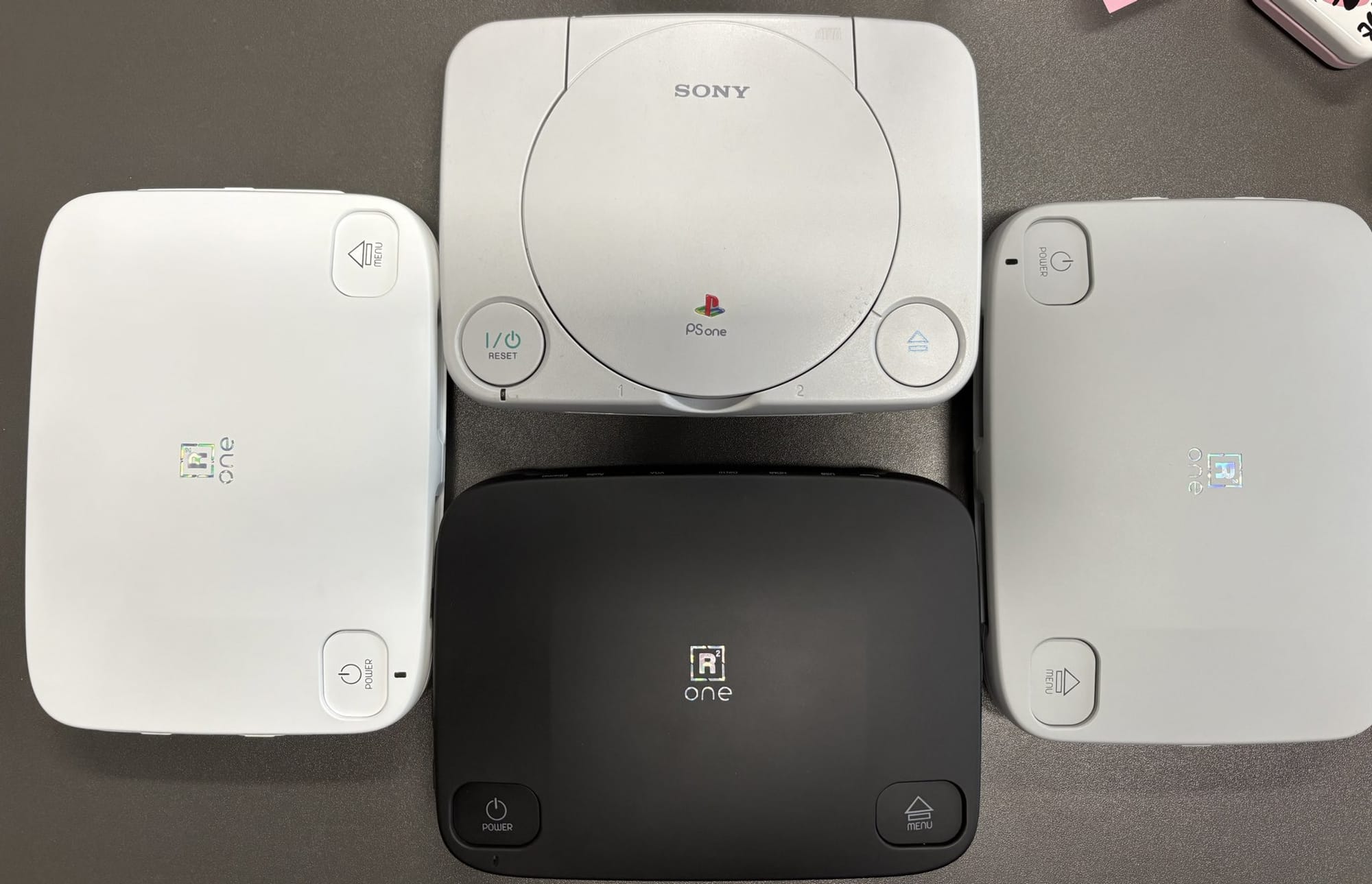 SuperStation One designs next to the original Sony PSone, via Taki Udon